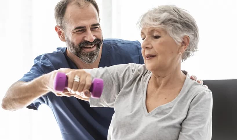 A trainer helping a woman exercise