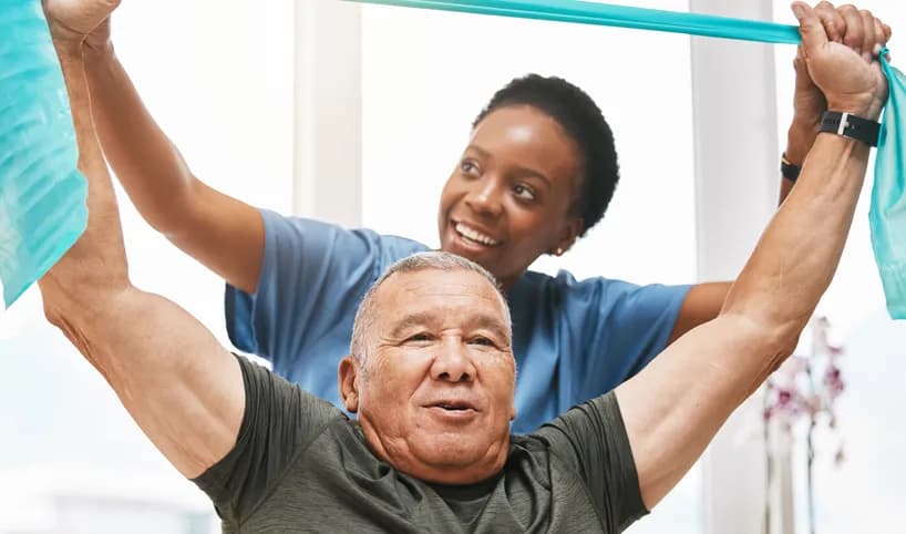 A physician helping a man exercise